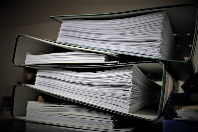 Large stack of paperwork and financial documents representing bookkeeping and VAT admin